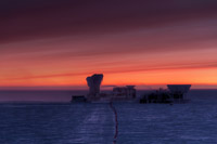The sun rises behind the CMB telescopes at the National Science Foundation’s South Pole Station. (<i>Steffen Richter, Harvard University</i>)
